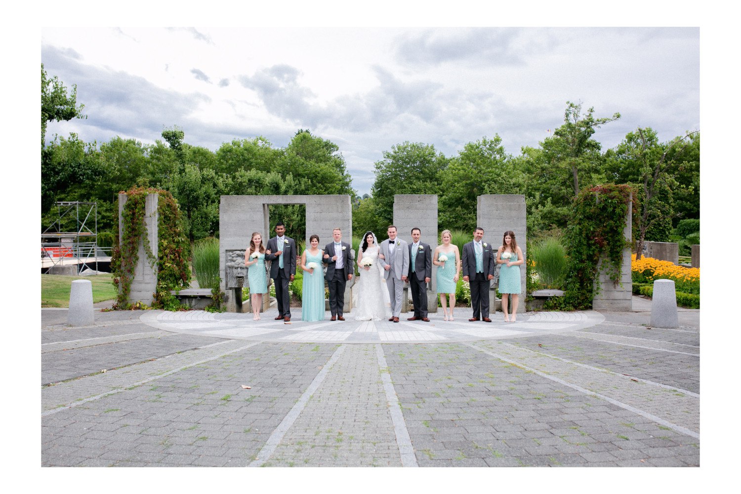 Wide portrait of the wedding bridal party at Italian Garden at Hastings Park in Vancouver.