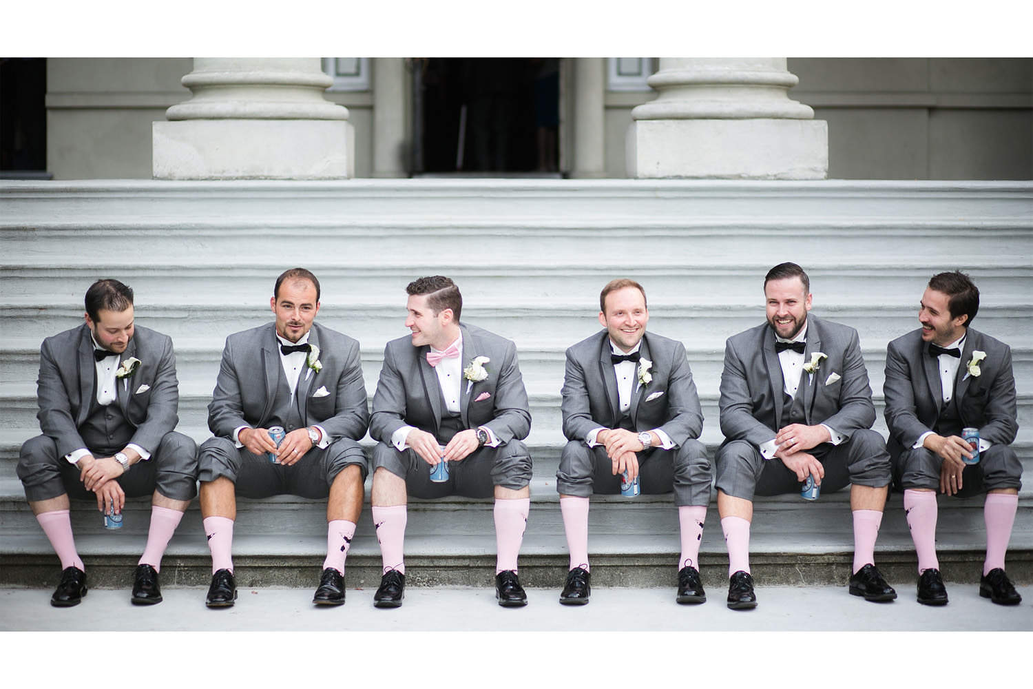 Groomsmen sitting on steps at Hycroft Manor in Vancouver as part of bridal party photos.