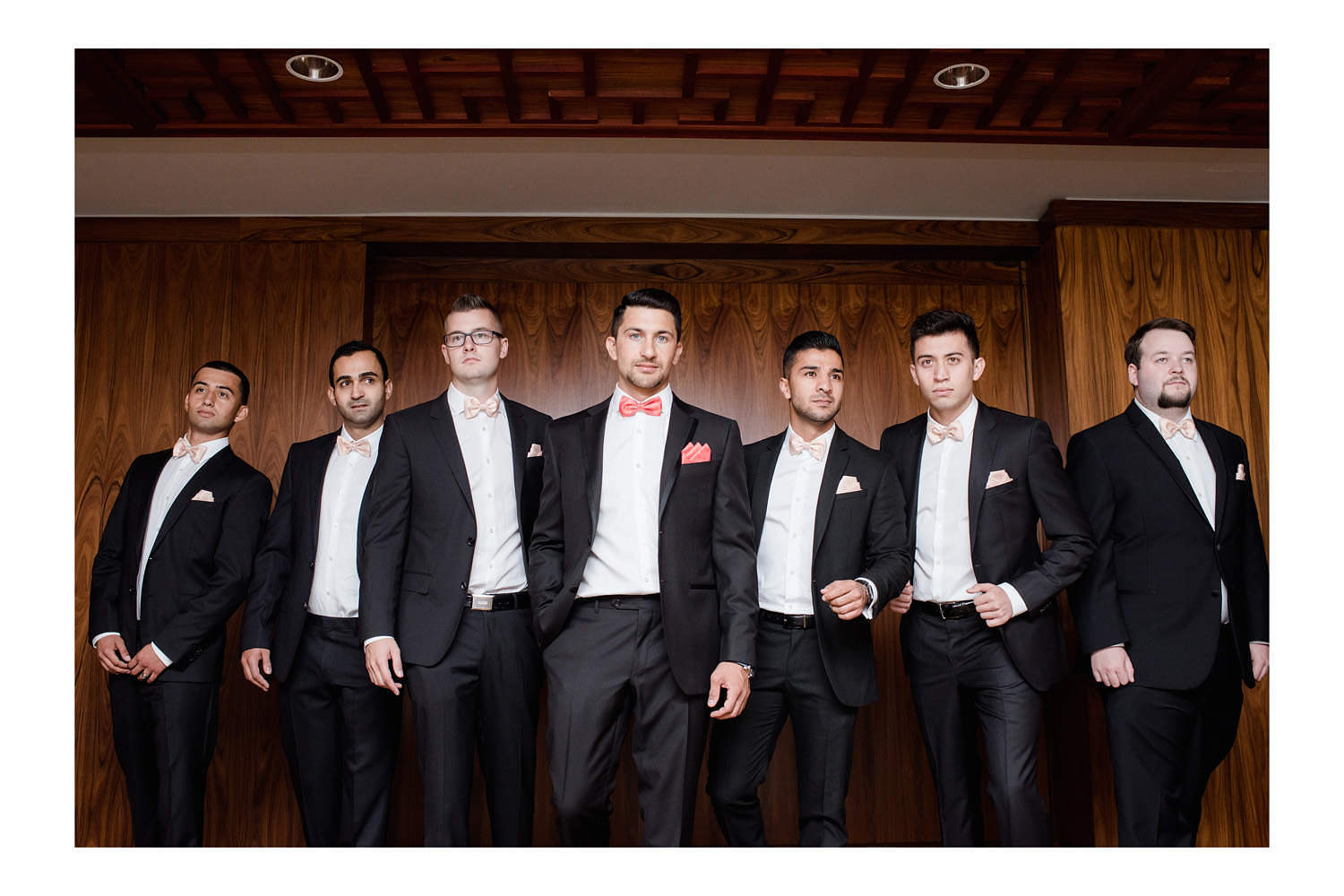 Groomsmen posing at Shangri La Hotel in Vancouver during bridal party photos.