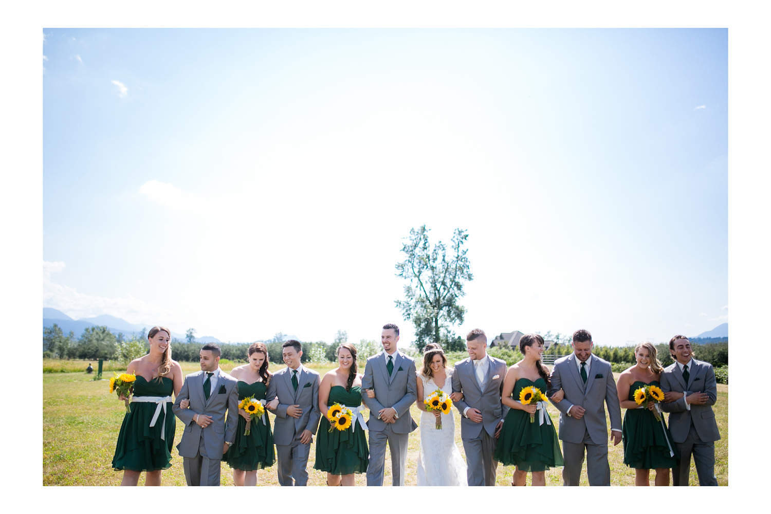 Bridal party walking on field at Fraser River Fishing Lodge.