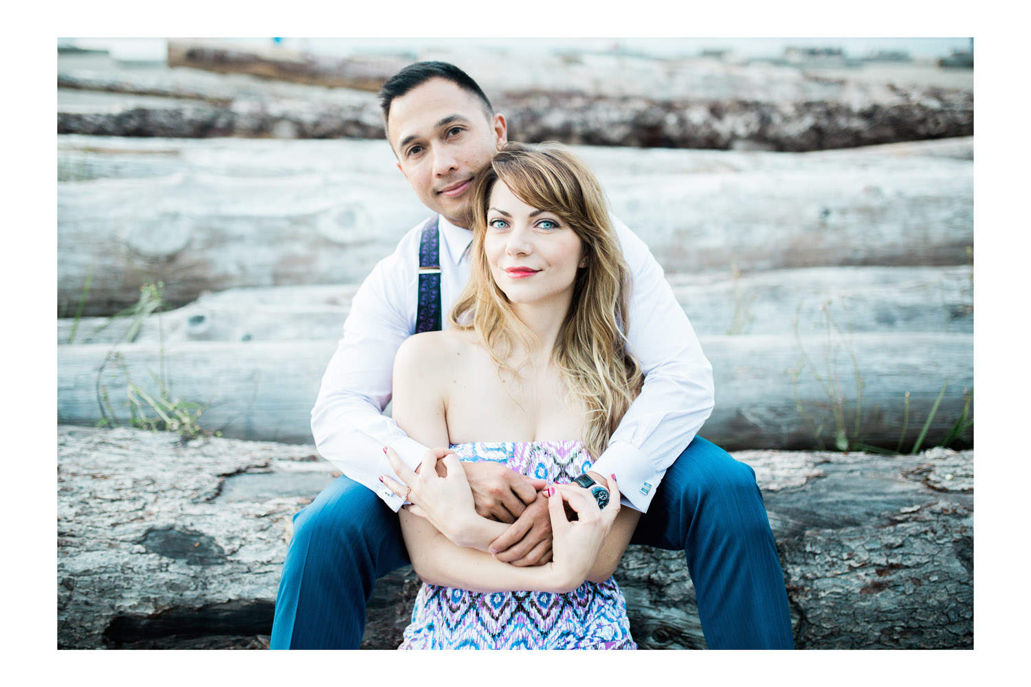 couple on log during engagement session at jericho beach