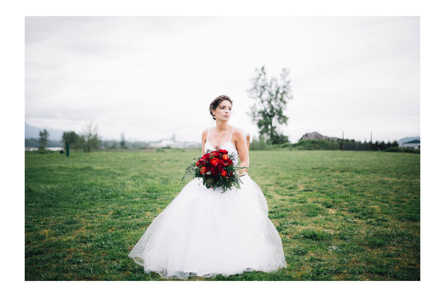 Bride sits on a chair during fairytale bridal shoot at Fraser River Fishing Lodge.
