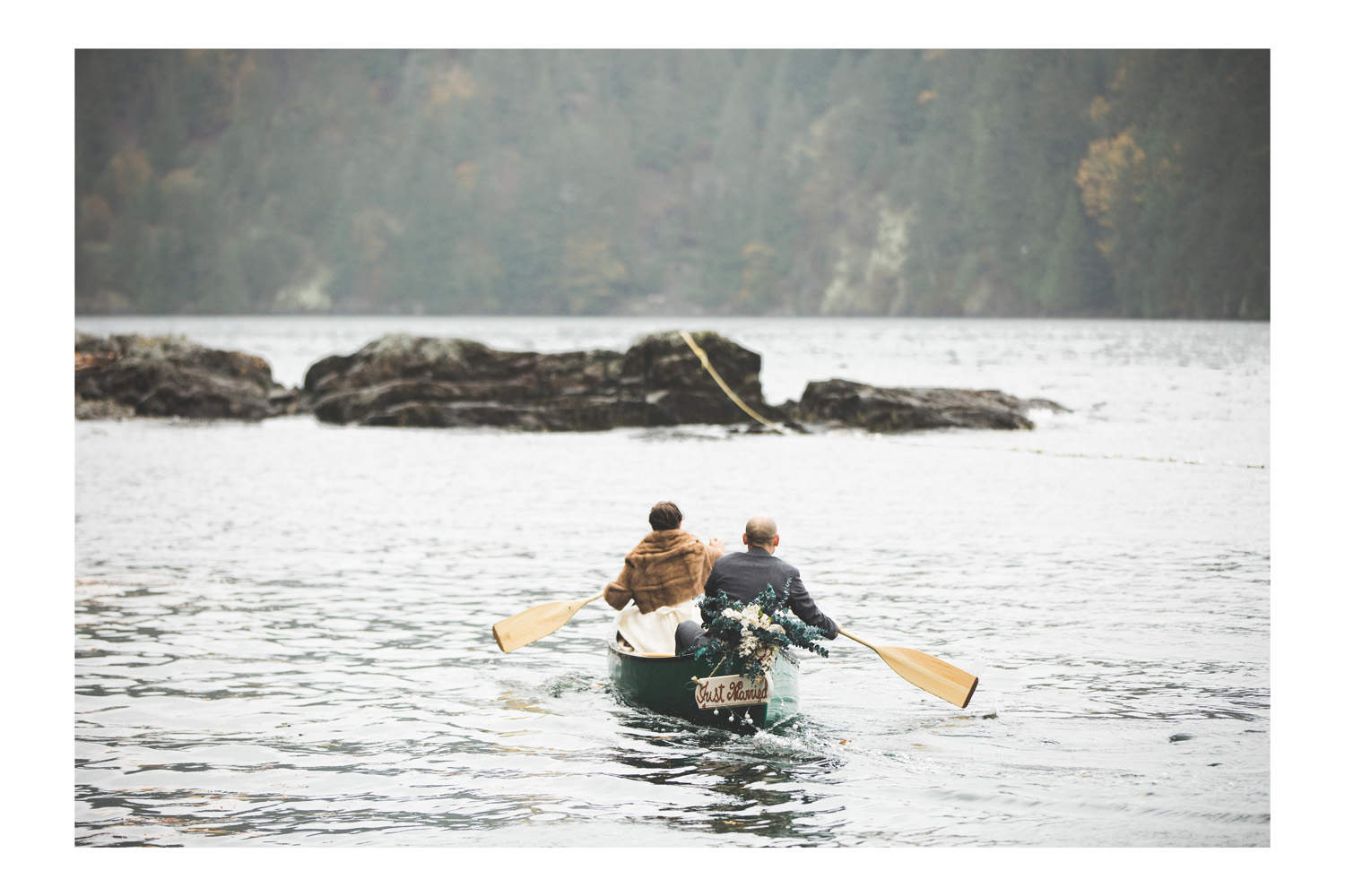 Gambier Island wedding bride and groom in a canoe