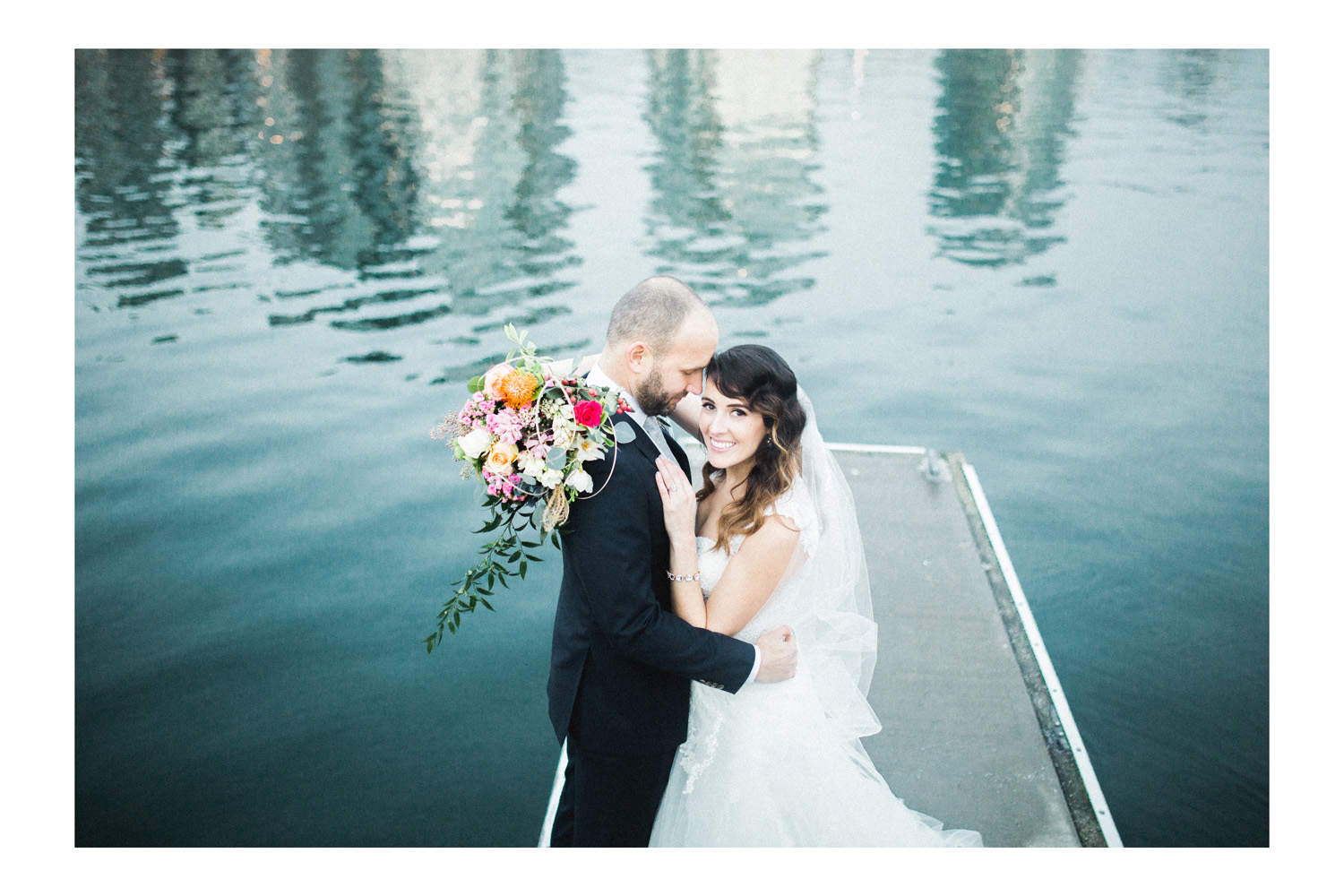 Vancouver wedding photographer image of the couple posing during formal portraits at Granville Island.